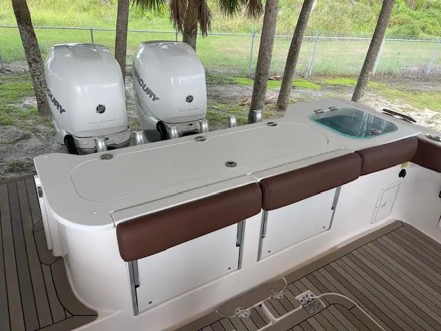  Yacht Photos Pics 2014 Everglades 325 Center Console boat with twin Mercury engines and cushioned seating.