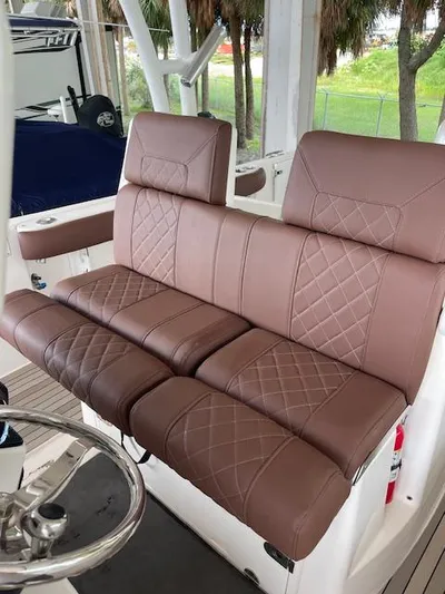  Yacht Photos Pics Brown leather seating on 2014 Everglades 325 Center Console boat, featuring diamond stitching.