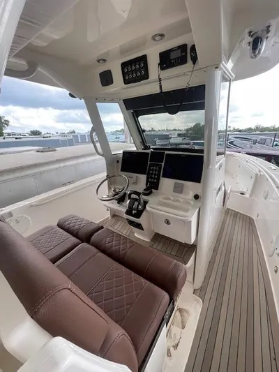  Yacht Photos Pics 2014 Everglades 325 Center Console boat interior with brown seating and modern controls.