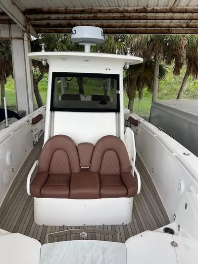  Yacht Photos Pics 2014 Everglades 325 Center Console boat with brown seating under a canopy.