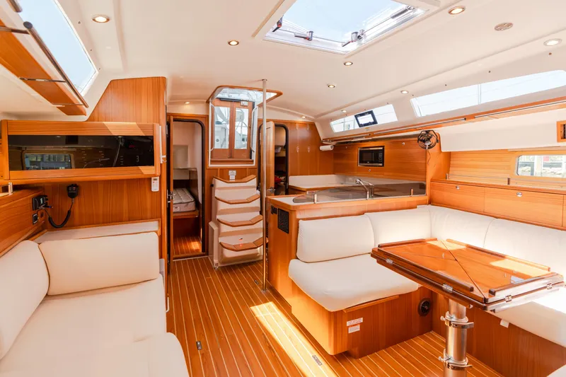 Age Gap Yacht Photos Pics Luxurious interior of 2023 Catalina 425 yacht with modern wood finish and spacious seating.