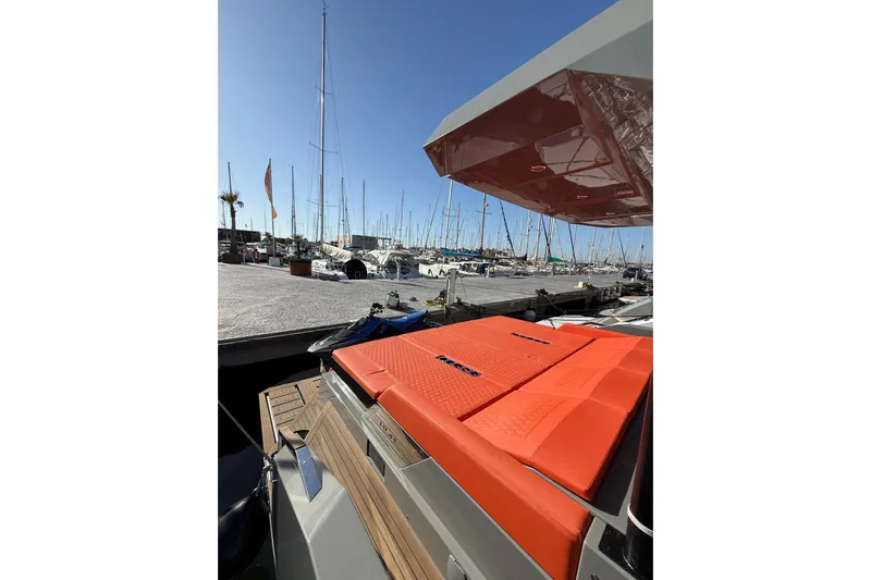  Yacht Photos Pics 2024 De Antonio Yachts D50 with vibrant orange seating at a marina.
