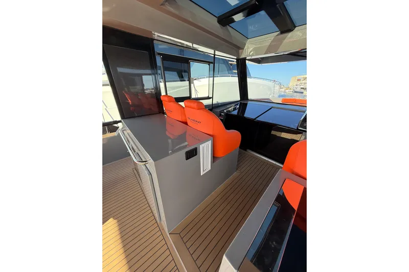  Yacht Photos Pics 2024 De Antonio Yachts D50 interior with orange seats and sleek design.