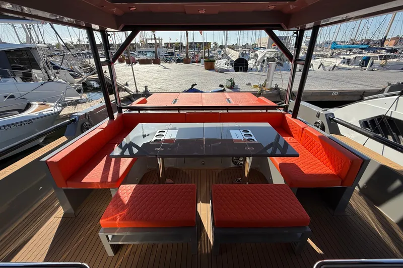  Yacht Photos Pics Luxurious 2024 De Antonio Yachts D50 with vibrant red seating and sleek dining area.