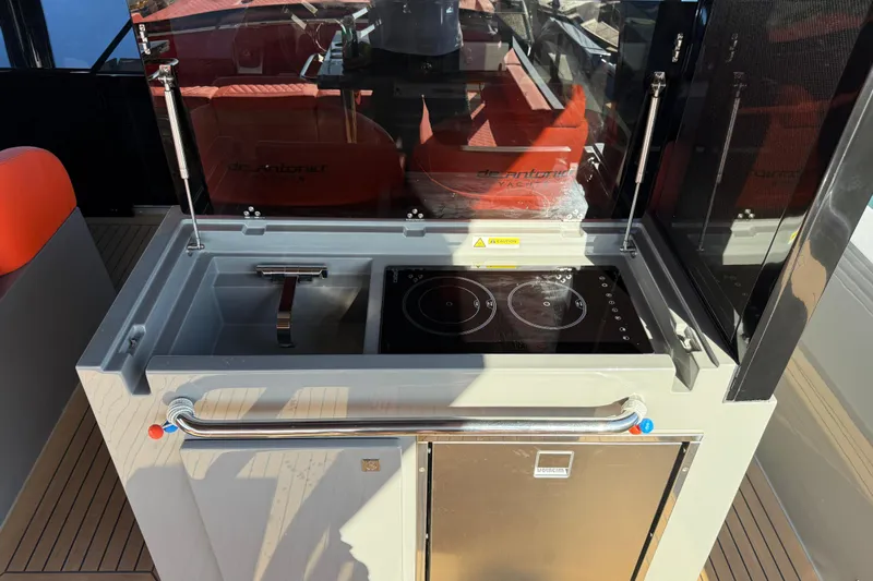  Yacht Photos Pics Outdoor kitchen on 2024 De Antonio Yachts D50 with sink and induction cooktop.