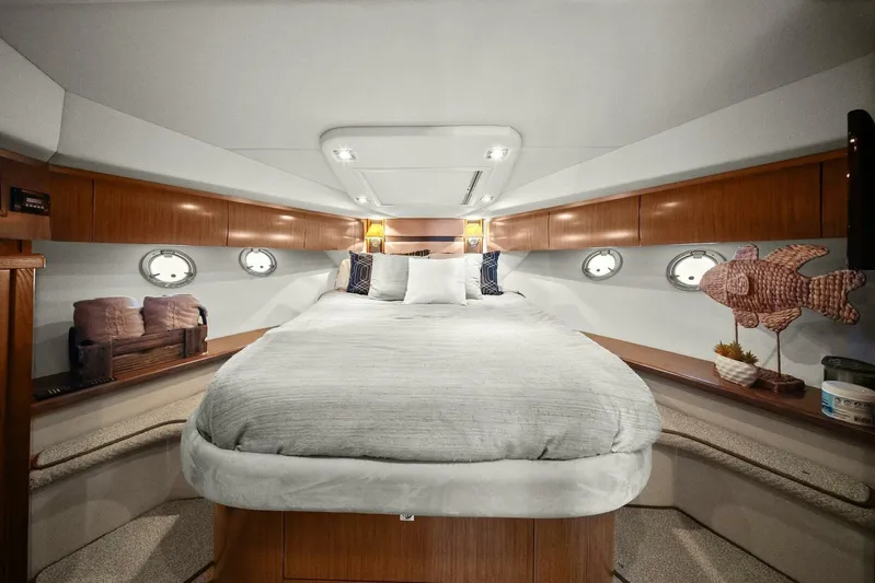 Shoes Knot Allowed Yacht Photos Pics Luxurious 2014 Cruisers Yachts 540 Sports Coupe bedroom with elegant wood accents and cozy bedding.