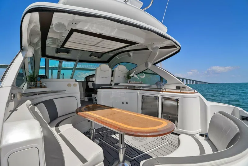 Shoes Knot Allowed Yacht Photos Pics Luxurious 2014 Cruisers Yachts 540 Sports Coupe interior with elegant seating and ocean view.