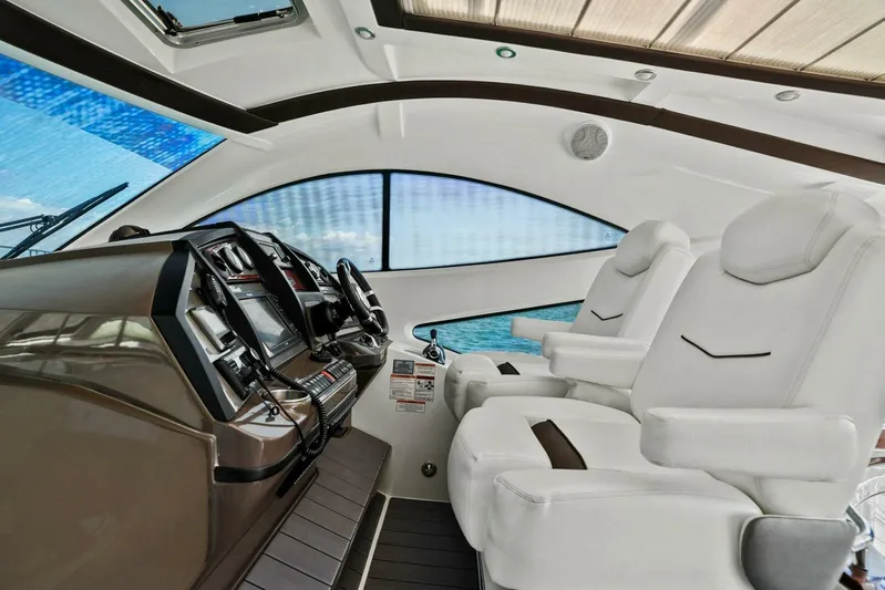 Shoes Knot Allowed Yacht Photos Pics Interior of 2014 Cruisers Yachts 540 Sports Coupe with luxurious white seating and modern dashboard.