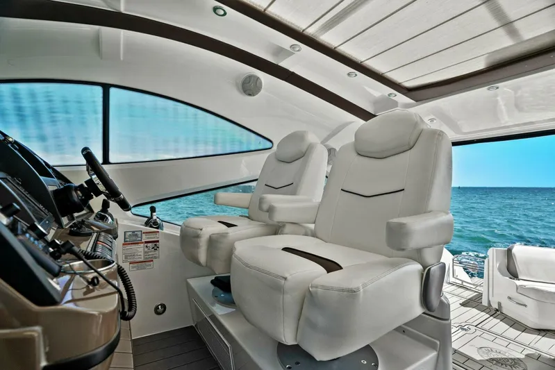Shoes Knot Allowed Yacht Photos Pics 2014 Cruisers Yachts 540 Sports Coupe interior with luxurious white seating and ocean view.