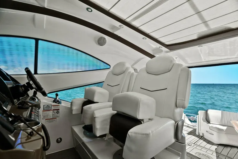 Shoes Knot Allowed Yacht Photos Pics 2014 Cruisers Yachts 540 Sports Coupe interior with luxurious white seating and ocean view.