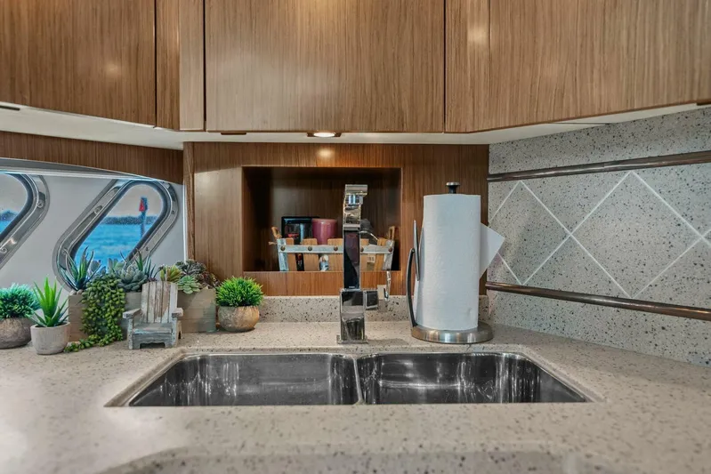 Shoes Knot Allowed Yacht Photos Pics Luxurious kitchen interior of 2014 Cruisers Yachts 540 Sports Coupe with modern fixtures.