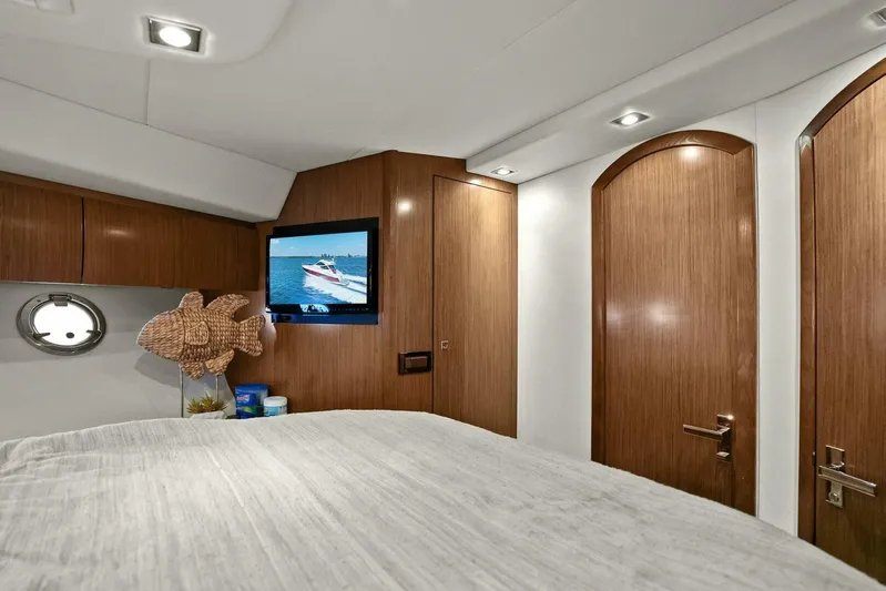 Shoes Knot Allowed Yacht Photos Pics Luxurious interior of 2014 Cruisers Yachts 540 Sports Coupe with wood finish and TV.