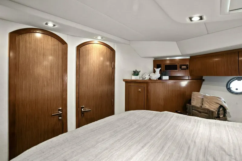 Shoes Knot Allowed Yacht Photos Pics Luxurious interior of 2014 Cruisers Yachts 540 Sports Coupe with wooden cabinetry and cozy decor.