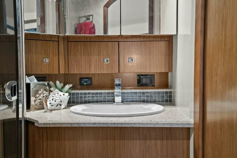 Shoes Knot Allowed Yacht Photos Pics Luxurious bathroom interior of 2014 Cruisers Yachts 540 Sports Coupe with modern sink and wooden cabinetry.