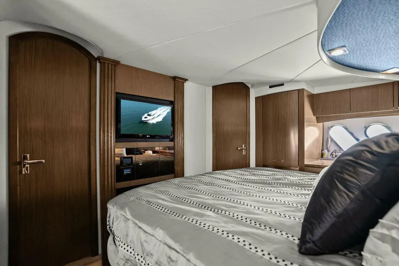 Shoes Knot Allowed Yacht Photos Pics Luxurious bedroom interior of 2014 Cruisers Yachts 540 Sports Coupe with TV and elegant wood finish.