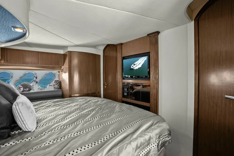 Shoes Knot Allowed Yacht Photos Pics Luxurious bedroom interior of 2014 Cruisers Yachts 540 Sports Coupe with wood accents and TV.