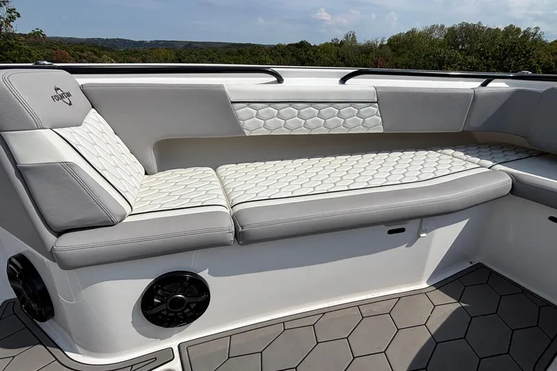  Yacht Photos Pics 2022 Fountain 38 SC boat interior with hexagonal-patterned seating and scenic background.