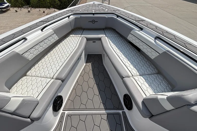  Yacht Photos Pics 2022 Fountain 38 SC boat interior with hexagonal-patterned seating and gray flooring.