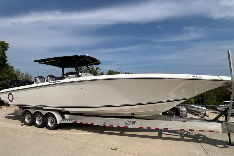  Yacht Photos Pics 2022 Fountain 38 SC boat on trailer, parked outdoors under a clear sky.