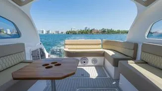 Custom Order You 375 Today! Yacht Photos Pics 2025 Hanover 375 Inboard boat interior with seating and table, overlooking a scenic water view.