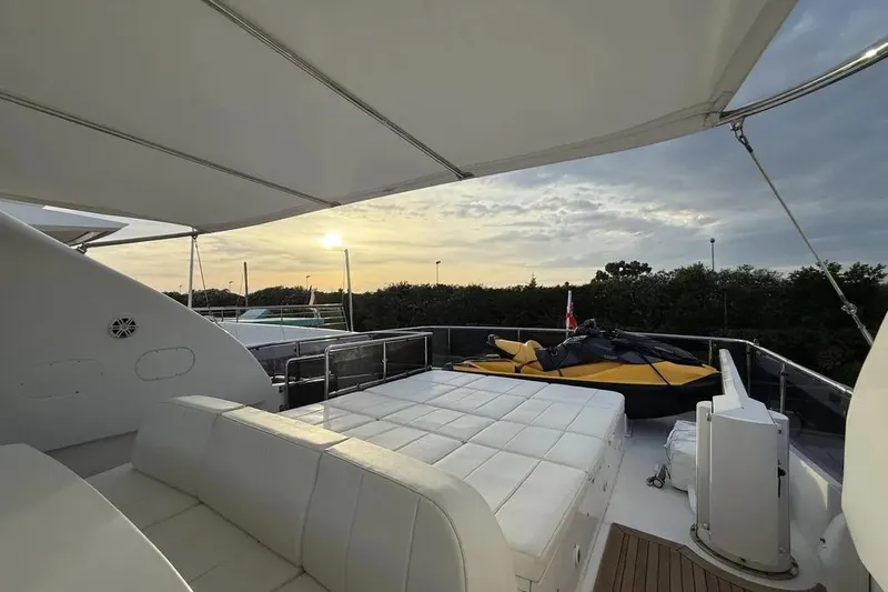  Yacht Photos Pics Luxurious 2009 Maiora 27 yacht deck with sunbed and jet ski at sunset.