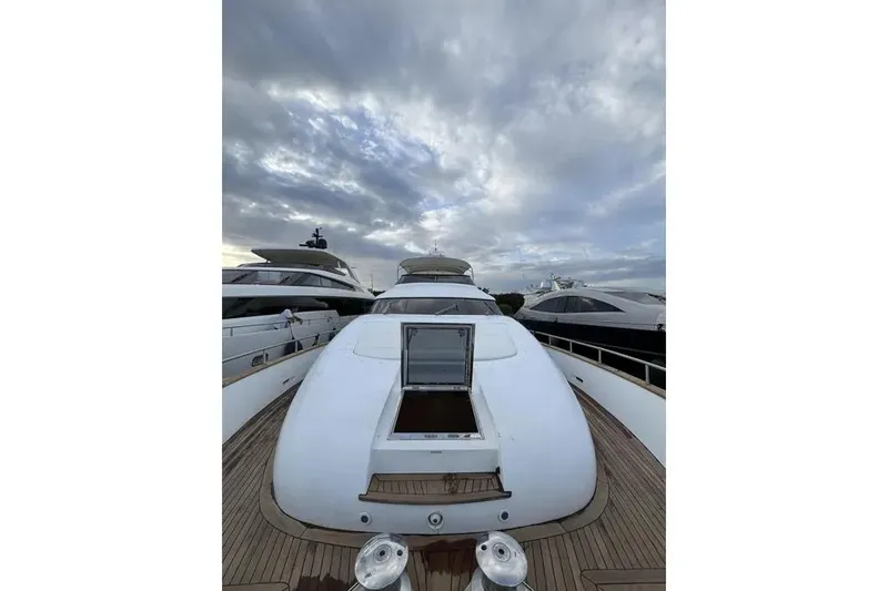  Yacht Photos Pics 2009 Maiora 27 yacht deck under cloudy sky, docked alongside other boats.