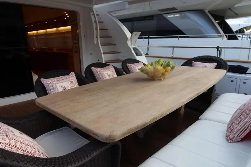  Yacht Photos Pics Luxurious dining area on 2009 Maiora 27 yacht with elegant table and cushioned seating.