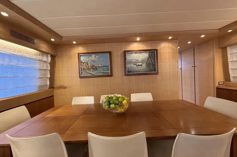  Yacht Photos Pics Luxurious dining area on 2009 Maiora 27 yacht with elegant decor and fruit centerpiece.