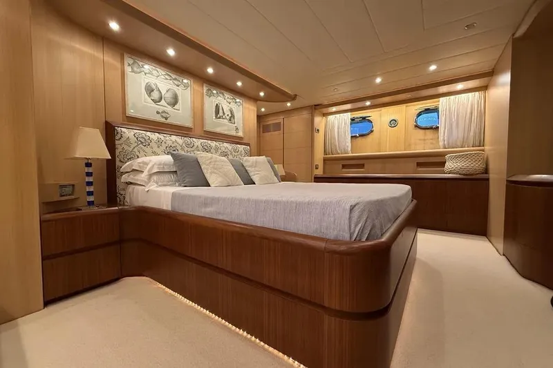  Yacht Photos Pics Luxurious Maiora 27 yacht bedroom interior, 2009 model, featuring elegant wood finishes and ambient lighting.