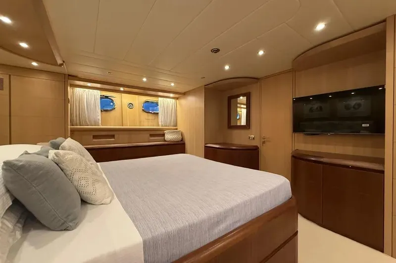  Yacht Photos Pics Luxurious bedroom interior of 2009 Maiora 27 yacht with modern furnishings and ambient lighting.