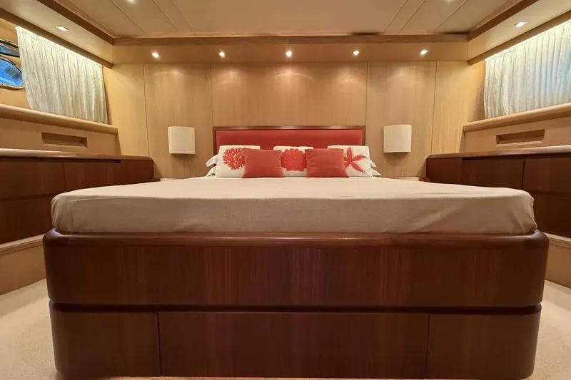  Yacht Photos Pics Luxurious bedroom interior of 2009 Maiora 27 yacht with elegant wood finishes.