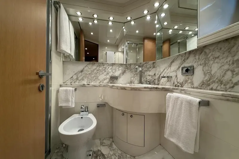  Yacht Photos Pics Luxurious marble bathroom in a 2009 Maiora 27 yacht, featuring elegant fixtures and ample lighting.