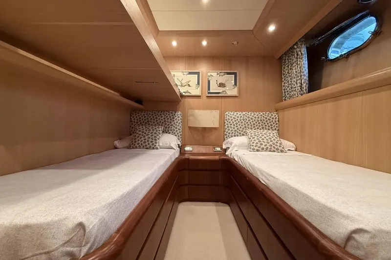  Yacht Photos Pics Luxurious twin cabin interior of 2009 Maiora 27 yacht with elegant wood finish.