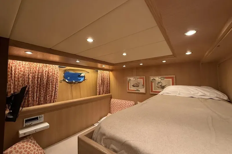  Yacht Photos Pics Luxurious cabin interior of 2009 Maiora 27 yacht with cozy bed and elegant decor.