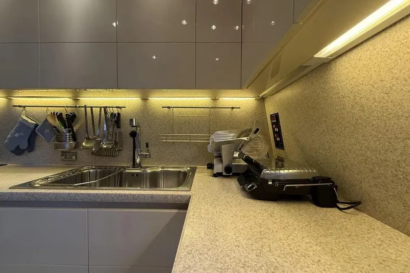  Yacht Photos Pics Modern kitchen on Maiora 27 yacht, 2009, with sleek countertops and stainless steel sink.