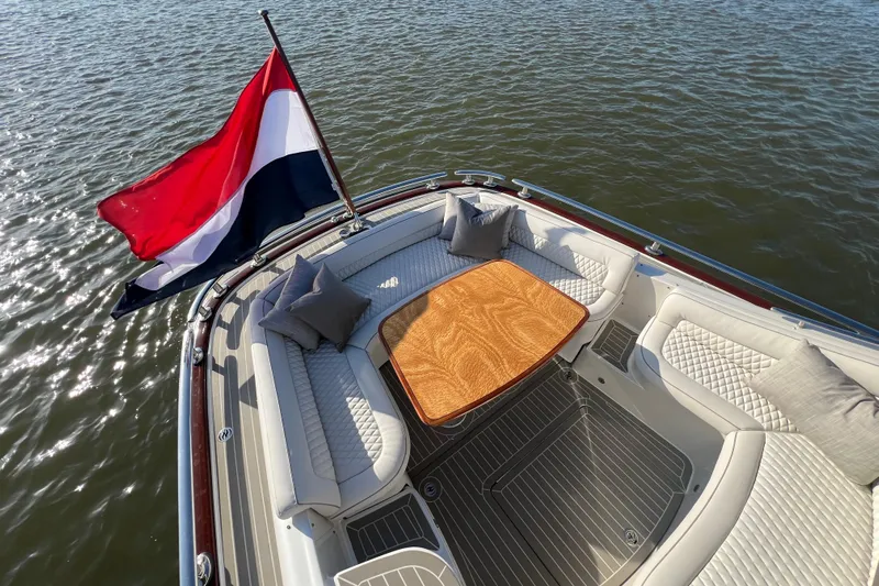 La Koko Yacht Photos Pics Luxurious 2012 Zeelander Z44 yacht with elegant seating and flag on calm water.