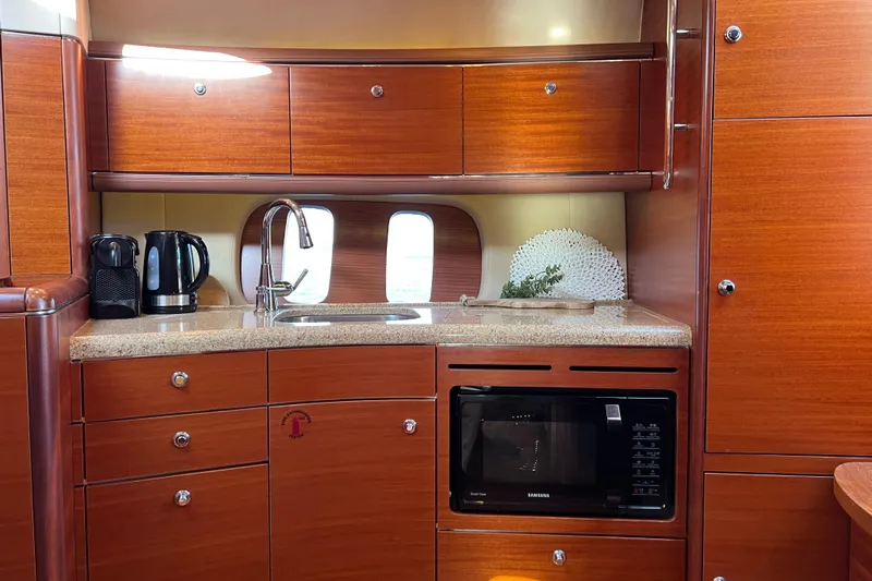 La Koko Yacht Photos Pics Luxurious 2012 Zeelander Z44 yacht kitchen with wood cabinetry and modern appliances.