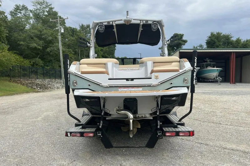  Yacht Photos Pics 2022 Nautique Super Air Nautique G23 boat rear view in outdoor setting.