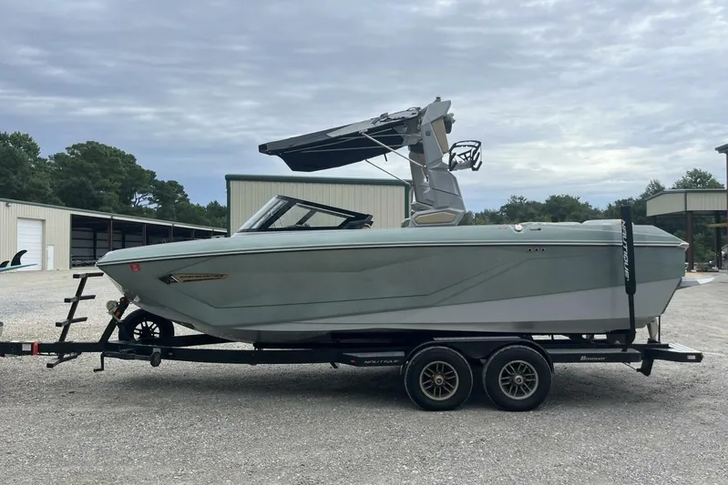 Yacht Photos Pics 2022 Nautique Super Air Nautique G23 boat on trailer, parked outdoors.