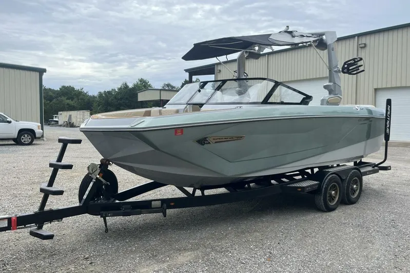  Yacht Photos Pics 2022 Nautique Super Air Nautique G23 boat on trailer, parked outdoors.