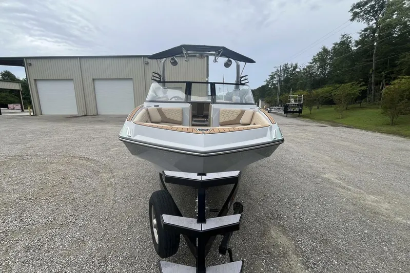  Yacht Photos Pics 2022 Nautique Super Air Nautique G23 boat on trailer, parked outdoors.
