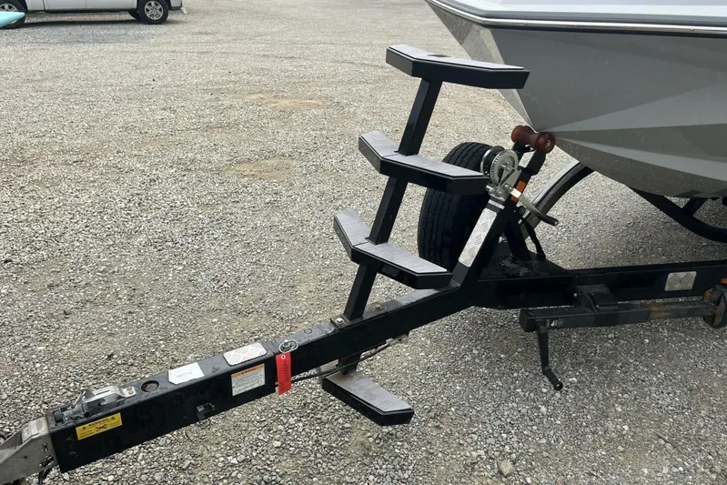  Yacht Photos Pics Trailer hitch and steps of 2022 Nautique Super Air Nautique G23 on gravel.