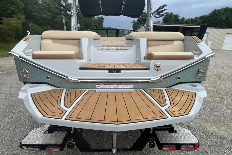  Yacht Photos Pics 2022 Nautique Super Air Nautique G23 boat with teak deck and cushioned seating.