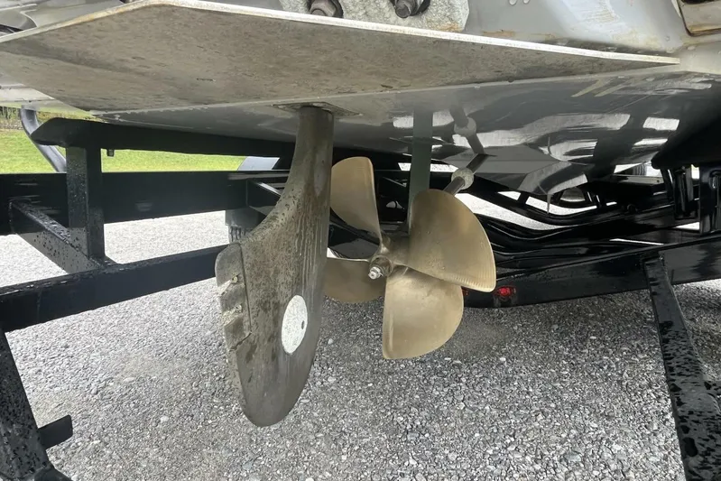  Yacht Photos Pics 2022 Nautique Super Air Nautique G23 propeller and rudder detail on trailer.