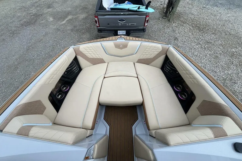  Yacht Photos Pics 2022 Nautique Super Air Nautique G23 boat interior with luxurious seating and cup holders.
