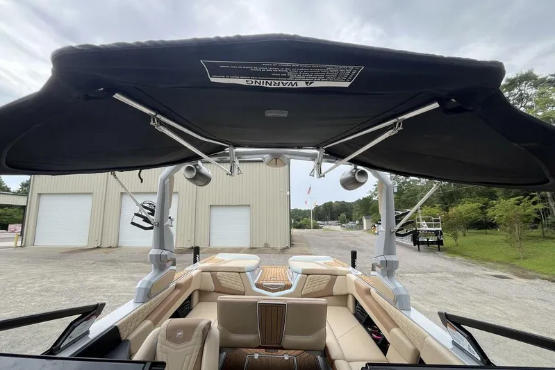  Yacht Photos Pics 2022 Nautique Super Air Nautique G23 boat interior with canopy and seating.