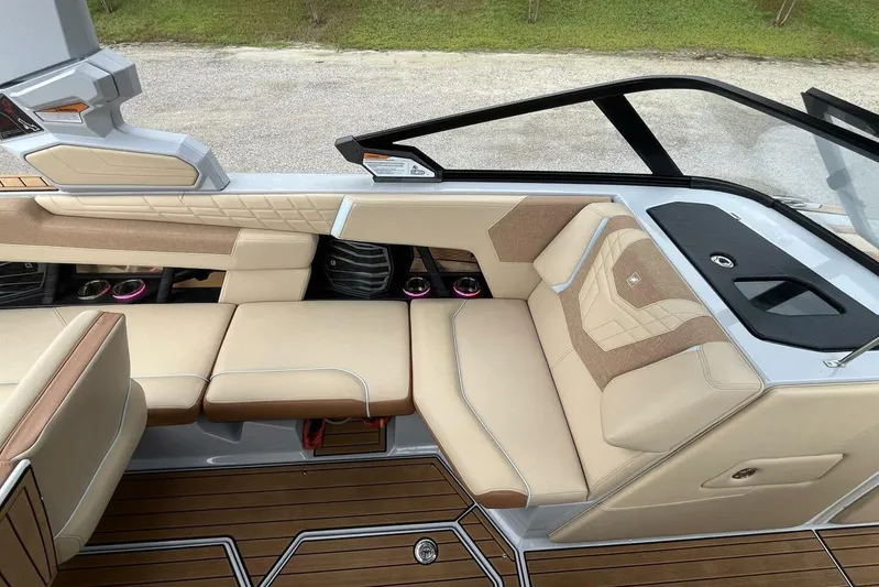  Yacht Photos Pics 2022 Nautique Super Air Nautique G23 interior with beige seating and modern design.