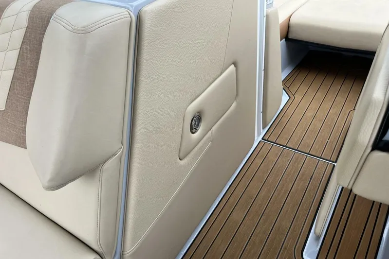  Yacht Photos Pics 2022 Nautique Super Air Nautique G23 interior with beige seating and wood-style flooring.