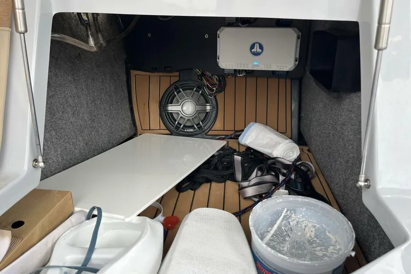  Yacht Photos Pics 2022 Nautique Super Air G23 storage compartment with audio equipment and accessories.