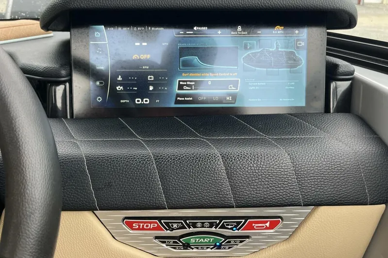  Yacht Photos Pics 2022 Nautique Super Air Nautique G23 dashboard with touchscreen controls and leather detailing.